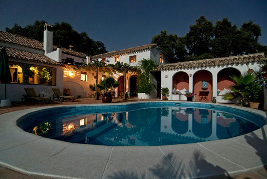 Mediterranean villa terrace with a pool at dusk